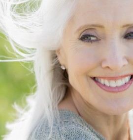 Contemplative mature woman with hand framing face