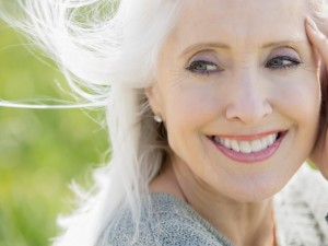 Contemplative mature woman with hand framing face